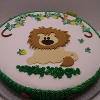 Lion Baby Shower Cake White cake with BC. Gumpaste jungle animals on side of cake as well.