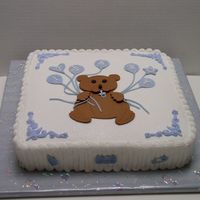 Little Brown Bear White cake with bc. Decorations made from a cutout pattern on top of cake. Inspired from a past Cake Craft & Decoration magazine.