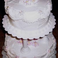 2-Tier Cake For Course 3 2-tier bridal shower cake - white BC frosting with light pink flowers and yellow centers.