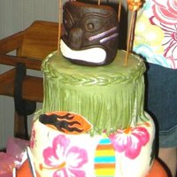 Hawaiian Theme Tiki Sunset Cake Three tier Hawaiian cake, rich vanilla with strawberry mousse and fresh strawberry filling, iced with strawberry BC and covered with MMF....