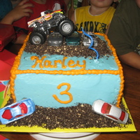 Monster Truck white cake with raspberry moouse filling buttercream icing. dirt is crushed oreos.