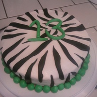 Zebra vanilla ccake with buttercream icing. i used the viva papertowel method for smoothing bc to look like fondant. used fondant accents.