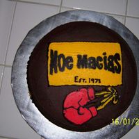 Boxing Birthday Cake chocolate cake with FBCT boxing gloves and brand name label.