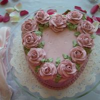 Valentines Heart Cake Strawberry cake w/ BC icing. Mauve roses made from royal icing.