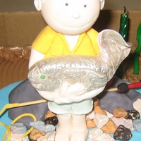 Fishing / Fisherman Figurine With Fish And Fishing Line Fisherman figurine modelled on birthday boy's photograph. 60th birthday celebration and he is a champion fisherman. Modelled from...