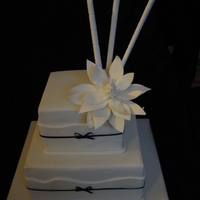 2 Tier Square Black And White Wedding Cake With Magnolia And Bamboo This was a cake I made in the fantastic Planetcake course I did last week. It is a 2 tier choclate mudcake with ganache and fondant. It has...