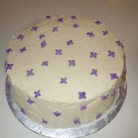 Sugared Lilacs Cake Simple white butter cake with creme ivorie frosting, sugared lilacs tucked in.