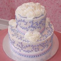 Purples Scrolls & White Flowers This is another Dummy cake I did for my display window. It is iced in Buttercream Icing and the roses are piped with Buttercream as well. I...