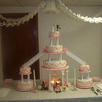 Pink Wedding Cake This is a huge cake, it is as big as it looks. It's a 6 10 and 14 center cakes with 6 and 10 inch satellite cakes on either side. This...