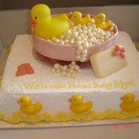 Duckies Cake is chocolate fudge with choclate mousse filling. Duckies, soap and booties are chocolate. Bath tub and bubbles are fondant.