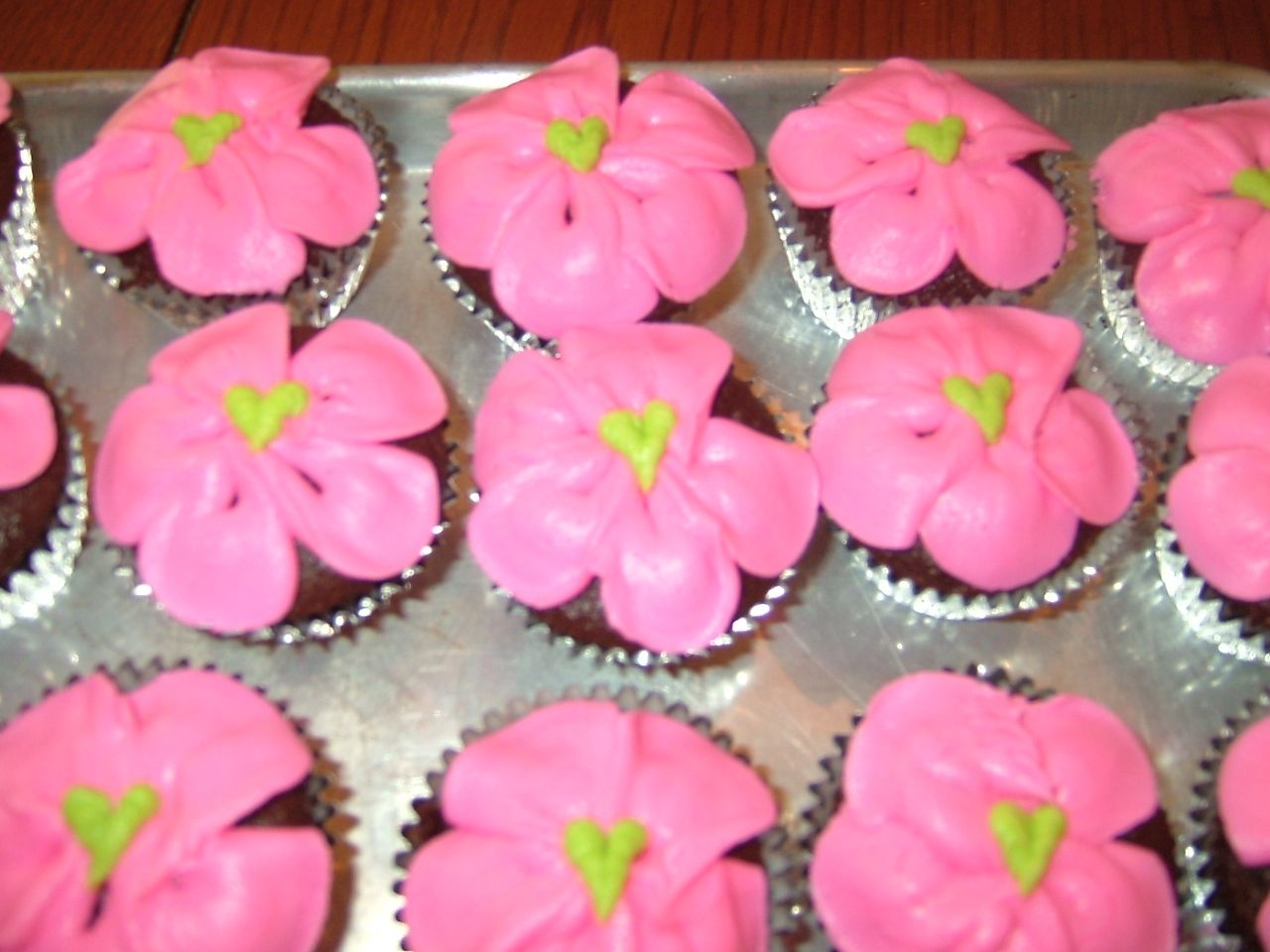 Flower Cupcake Made these cup cakes to go with a Tinkerbell Cake I made.Added heart center for a cute added touch