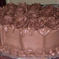 Chocolate Roses On Chocolate Cake This is a chocolate cake and bc icing, the roses were made ahead of time so that is why there is a difference in the color. Not happy about...