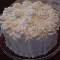 White Roses On White Cake Like my chocolate one this is bc roses on a white cake with vanilla pudding in the middle. Loved this cake, I think it was the best yet.