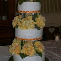 Round Wedding Cake 12" 10" 8" - each layer a different flavor. Ribbon with silk flowers in between each tier. Iced buttercreme
