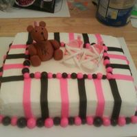 Punk Baby Shower chocolate cake and butter cream. The bear, stripes and balls were made with fondant. The shoes were made with gum paste.