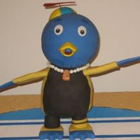 Pablo From The Backyardigans His head is a chocolate mini sports ball and his body is vanilla carved from a 12x18 stacked. His cap is fondant also and painted with...