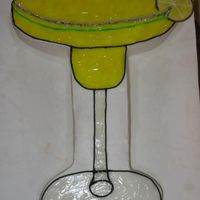 Margarita 12x18 yellow cake cut glass shape. Iced with BC and piping gel tinted with yellow and a touch of green.