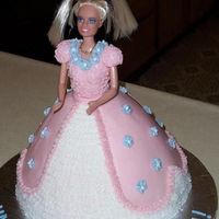 Barbie Cake I made this for my daughter's friend. Buttercream frosting with fondant accents. Royal icing for the drop flowers.