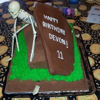 Skeleton Cake I made this for my nephew. The skeleton is plastic that I got at a craft store. The lid is frosting covered foam board. Cookie crumbs make...