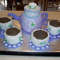 Teapot And Cups I made this for my mother's friend. First attempt at a teapot. Buttercream frosting, fondant accents. Gumpaste rose.