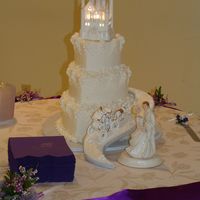 Fairytale Wedding Cake 3 tier heart cake in 6/9/12" sizes. Cake is iced in buttercream with buttercream and gumpaste flowers. Roadway is foamcore board iced...