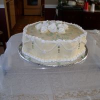First Sold Cake This cake was made for a bridal shower. It is a double layer marble 15inch petal pan, Ivory icing with white trim and juniper green leaves...