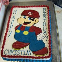 Super Mario Cake Super Mario themed birthday cake for a young boy.