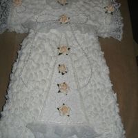 Baby Baptism Gown Used Buttercream white frosting, single layer.Accents used: lace, silk mini flowers, stirng pearls