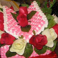 Basket Cake W/ Flowers 2 layer basket w/ lid.Used the basket weaving method 2 color flrosingFlowers silk roses