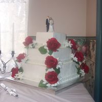 White Cake With Buttercream This was a White Chocolate Cake with Buttercream icing. The roses and stephanotis flowers are silk.