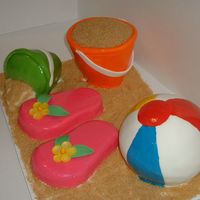 Day At The Beach Beach ball, flip flops, and two beach pails all covered in fondant. I cooked the buckets on flower pots to get the shape and cut the flip...