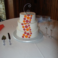 Round 8, 10, 12 in buttercream with fondant orange and magenta dots