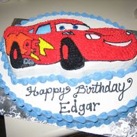 Cars Birthday Cake White cake with whipped icing and pattern transfer images. Reverse Shell border & open star tip cactii.