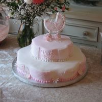 Pink Everywhere!!! Petal pan white cake, covered in white fondant. Quilt alternating detail, buttercream scrolls, gumpaste daisies, gumpaste carriage body...