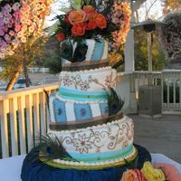 Leila's Whimsical Cake 8", 10", 12" and 14" different chocalate cakes. Covered in fondant, used daisey cutters for flower pattern to resemble...