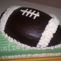 Football Birthday Cake Used the Wilton football cake pan and set it on top of a 1/4 sheet cake. I used a yellow cake with buttercream frosting.