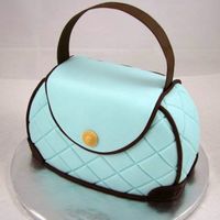 Tiffany Purse This cake was made from an 8 inch round, with the top and bottom cut off to form the purse. Covered in fondant and adorned with embossed...