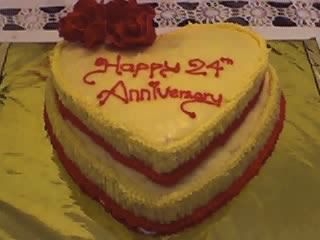 Our 24Th Wedding Anniversary Cake it was done in vanilla marble cake tio icing is with marshemellow satin and the sides are done with butter cream decorated with the sta...