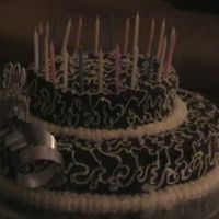 25Th Wedding Anniversary Cake chocolate cake done in two tires with choc fudge covered icing and decorated with butter cream icing scroll work and the boarders are done...