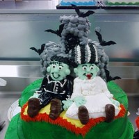 Frankenstein And His Bride For My Halloween Cake All Buttercream icing and plastic bats and signs. bodies of wedding couple are half a cupcake leaned against cake and iced. everything else...