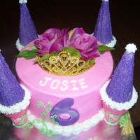 Ellie's Surprise Princess Cake A simple princess cake made with WASC, buttercream, ice cream cones. The flower and crown are fake.