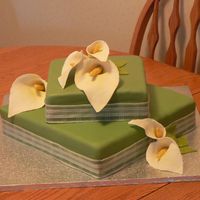 Calla Lily 12" and 8" fondant covered with gumpaste calla lilies. First time working with gumpaste. Can't wait to play with it more. I...