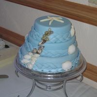 Ocean Theme Wedding Cake The bottom layer of this cake is two tone cheesecake. The top two layers are cake dummies. All three layers are covered in fondant. The...