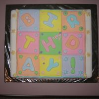 Quilt Birthday Cake. This is a dummy cake covered in fondant. It has royal icing and fondant accents.