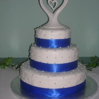 Blue & Silver Wedding All the silver balls are edible. Each layer is 3 cakes thick! Covered in fondant