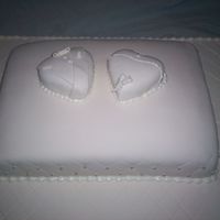 White-On-White 25th Anniversary cake; cushion shaped cake, covered with white fondant; quilted with silver dragees; topper = his & hers Hearts (his (...