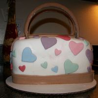 1St Dooney & Burke Purse Cake First attempt at purse cake. Practicing for daughter's birthday. I was happy with the way it turned out, but I still have a long way...