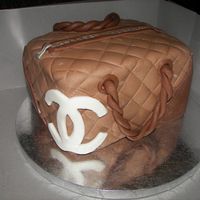 Chanel Purse Butter cake, chocolate fondant, with buttercream filling. First paid customers. Made for husband's co-worker's wife. He was very...