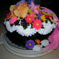 Morgan's 19Th Birthday Cake top of cake is white buttercream icing. lower portion of cake is a basket weave dark chocolate buttercream icing. flowers are made of...