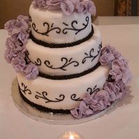 Wedding Cake Fondant cake with black royal icing scrollsand gum paste flowers.